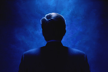 Image showing Silhouette of man bathed in blue light.