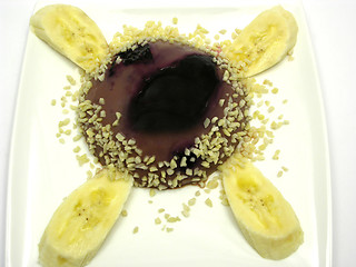 Image showing Chocolate pudding with blueberries, banana and pieces of almonds