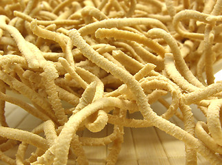 Image showing A close up view at uncooked wholemeal spaetzle on a placemat