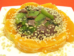Image showing Chocolate pudding with kiwi fruit, orange and little pieces of a