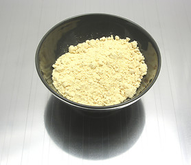 Image showing Bowl of chinaware with soy meal on reflecting matting