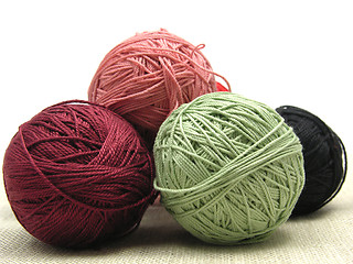 Image showing A few balls of wool  on a beige background