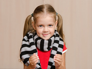 Image showing Girl with sore throat is holding a certain object