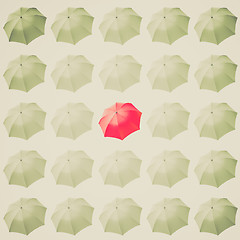 Image showing Retro look Red umbrella among white
