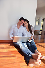 Image showing relaxed young couple working on laptop computer at home