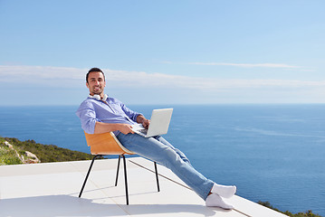 Image showing relaxed young man at home on balcony