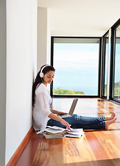 Image showing relaxed young woman at home working on laptop