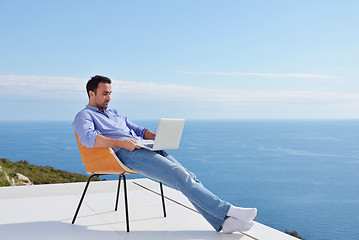 Image showing relaxed young man at home on balcony