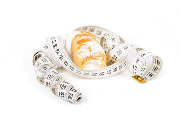 Image showing concept of slimming, cakes with measuring tape