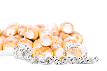 Image showing concept of slimming, cakes with measuring tape