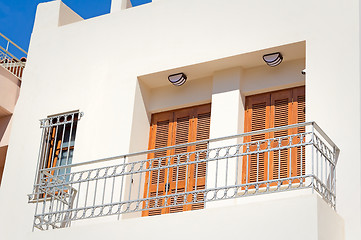 Image showing Fragment of a facade of a house with a balcony and blinds from t