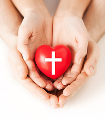 Image showing couple hands holding heart with cross symbol