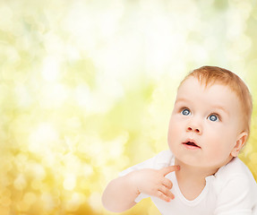 Image showing curious baby looking up