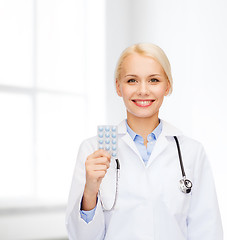 Image showing smiling female doctor with pills