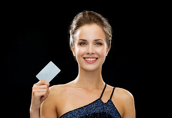 Image showing smiling woman in evening dress holding credit card