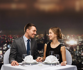 Image showing smiling couple looking at each other at restaurant