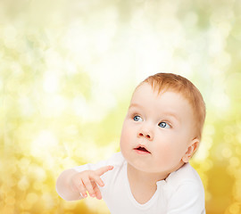 Image showing curious baby looking side