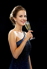 Image showing smiling woman holding glass of sparkling wine