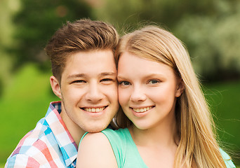 Image showing smiling couple hugging in park