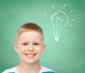 Image showing smiling little boy over green board background
