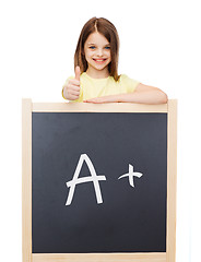 Image showing smiling girl with blackboard showing thumbs up