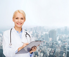 Image showing smiling female doctor with clipboard