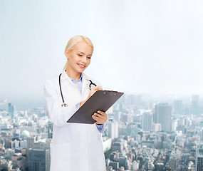 Image showing smiling female doctor with clipboard