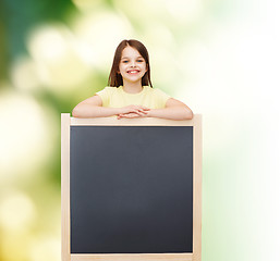 Image showing happy little girl with blank blackboard