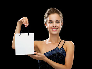 Image showing smiling woman with white blank shopping bag