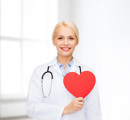 Image showing smiling female doctor with heart and stethoscope