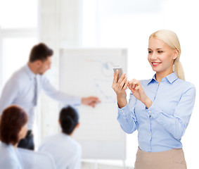 Image showing young smiling businesswoman with smartphone