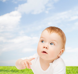 Image showing curious baby looking side