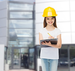 Image showing smiling little girl in hardhat with clipboard