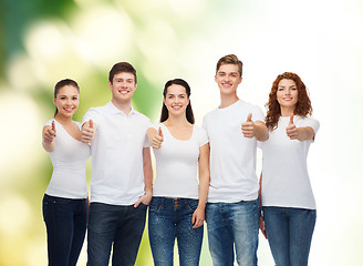 Image showing smiling teenagers in t-shirts showing thumbs up