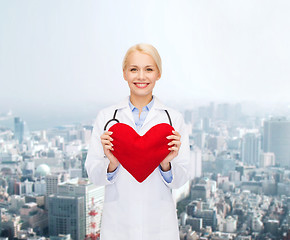 Image showing smiling female doctor with heart and stethoscope