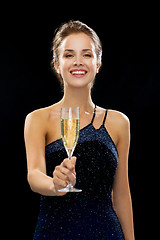 Image showing smiling woman holding glass of sparkling wine