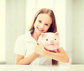 Image showing child with piggy bank