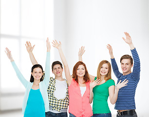 Image showing group of smiling students waving hands