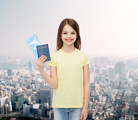 Image showing smiling little girl with ticket and passport