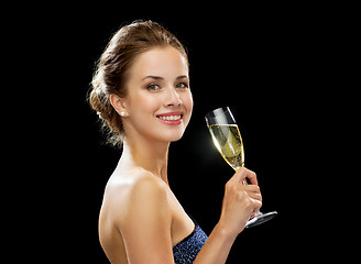 Image showing smiling woman holding glass of sparkling wine