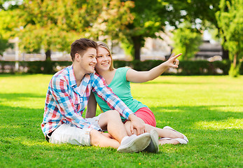 Image showing smiling couple sitting on grass in park