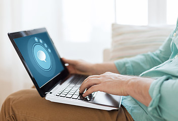 Image showing close up of man working with laptop at home