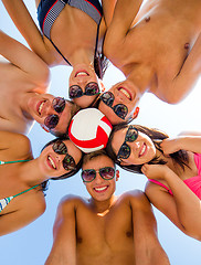 Image showing smiling friends in circle on summer beach