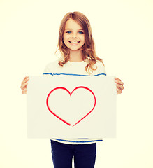 Image showing smiling little child holding picture of heart