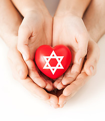 Image showing couple hands holding heart with star of david
