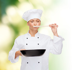 Image showing smiling female chef with pan and spoon