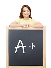 Image showing happy little girl with blank blackboard