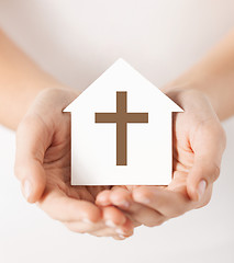 Image showing hands holding paper house with cross symbol