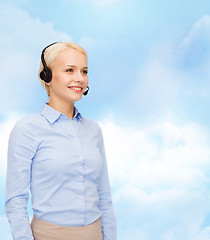 Image showing friendly female helpline operator with headphones