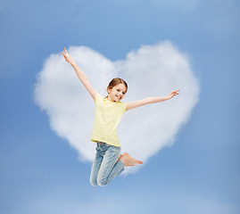 Image showing smiling little girl jumping